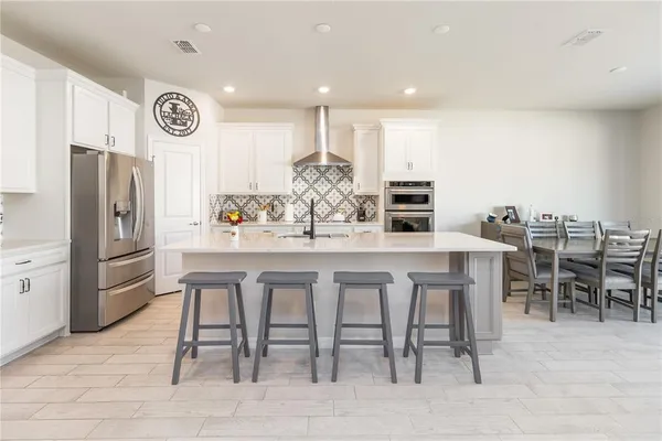 a view of a dining room with furniture and a floor to ceiling window