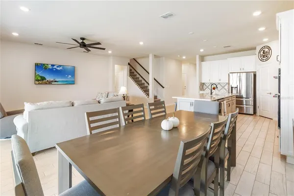 a living room with furniture and a ceiling fan