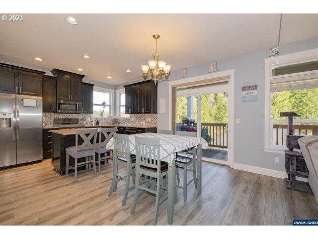 341 Boulder Ridge Drive Sweet Home, OR 97386 - Photo 18 of 32 a dining room with furniture a chandelier and wooden floor