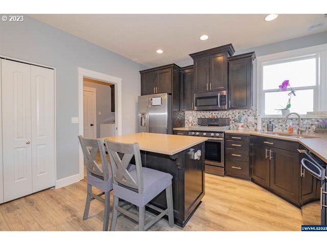 341 Boulder Ridge Drive Sweet Home, OR 97386 - Photo 7 of 32 a kitchen with kitchen island a sink table and chairs