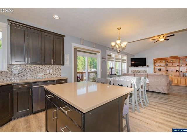 341 Boulder Ridge Drive Sweet Home, OR 97386 - Photo 8 of 32 a kitchen with a kitchen island a stove a table and chairs