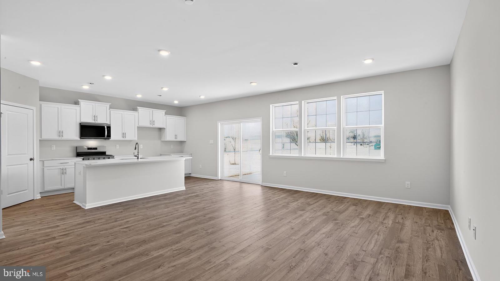 a view of kitchen with wooden floor and window