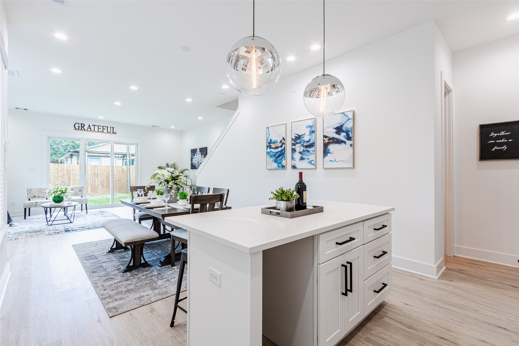 6814 Burkett Street, Unit B Houston, TX 77021 - Photo 11 of 30 a living room with kitchen island furniture and a chandelier