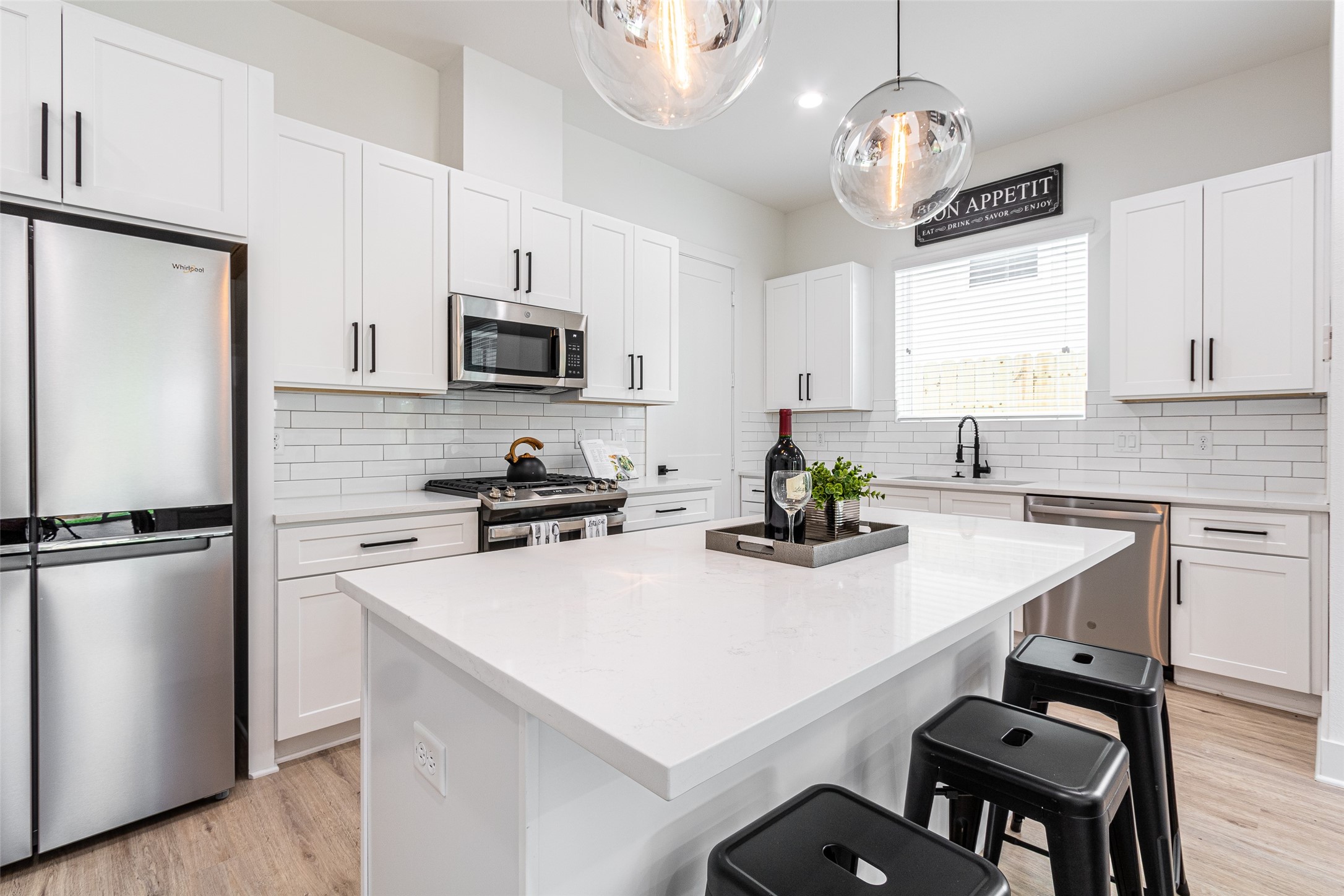 6814 Burkett Street, Unit B Houston, TX 77021 - Photo 12 of 30 a kitchen with a center island and stainless steel appliances