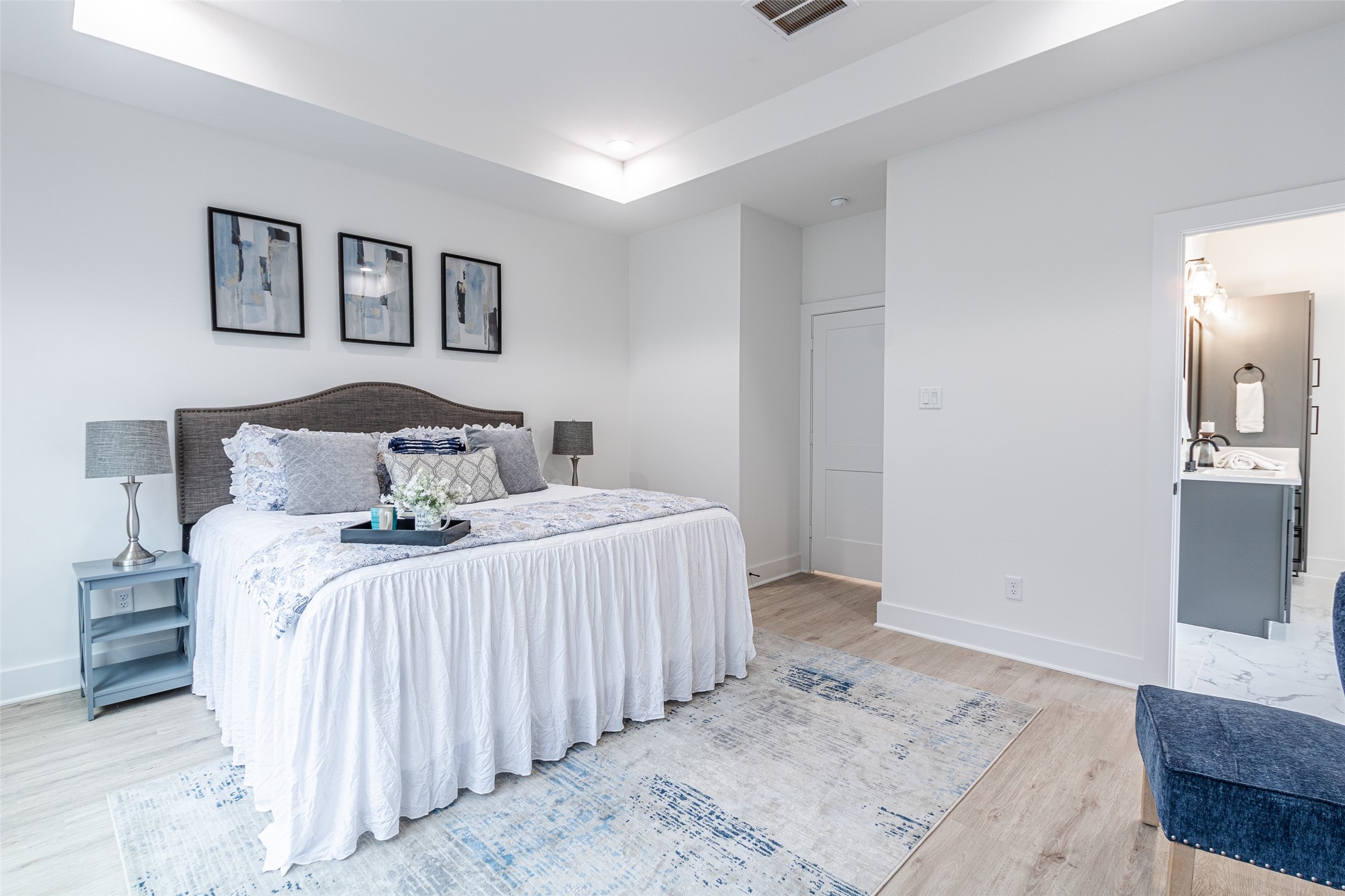 6814 Burkett Street, Unit B Houston, TX 77021 - Photo 16 of 30 a bedroom with a large bed and a flat screen tv