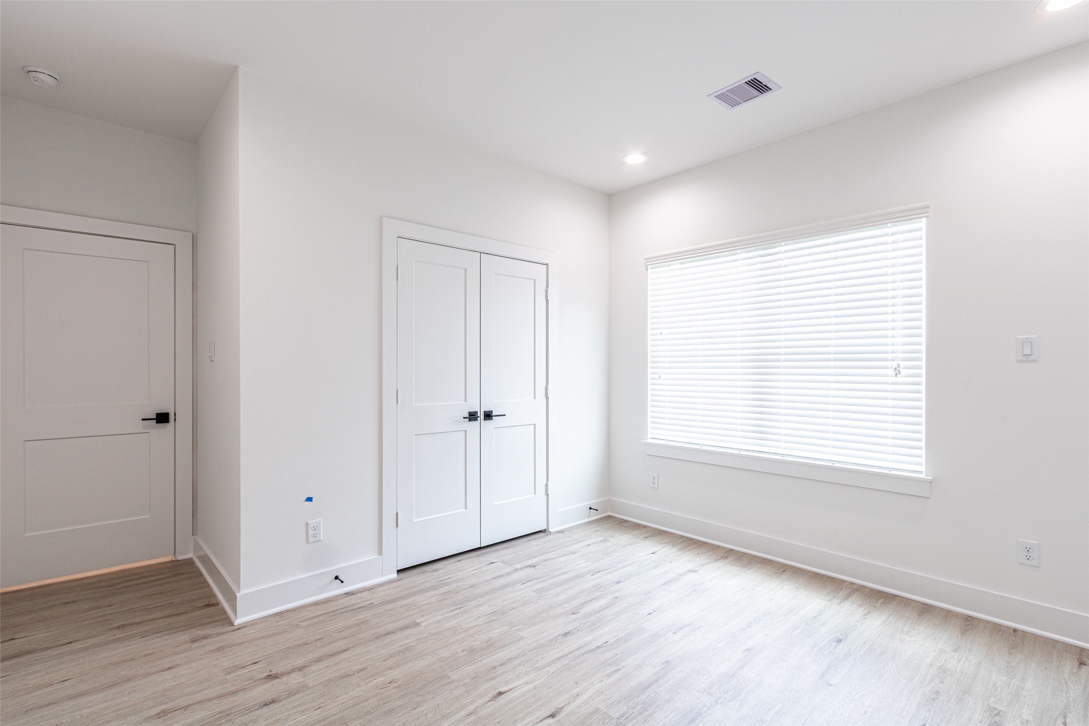 6814 Burkett Street, Unit B Houston, TX 77021 - Photo 27 of 30 a view of an empty room with wooden floor and a window