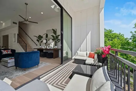 a living room with furniture and stairs