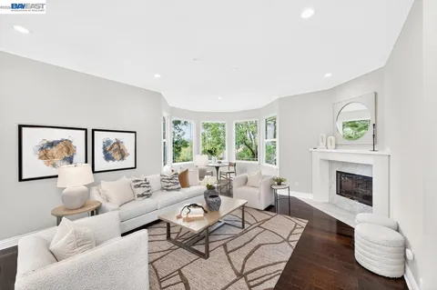 a kitchen with stainless steel appliances kitchen island granite countertop a wooden floor and white cabinets
