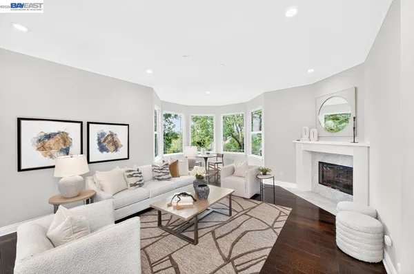 a kitchen with stainless steel appliances kitchen island granite countertop a wooden floor and white cabinets