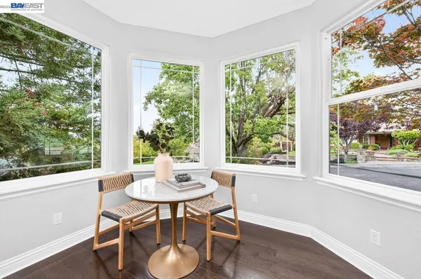 a large kitchen with kitchen island white cabinets and stainless steel appliances