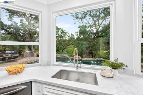 a spacious bathroom with a granite countertop sink a mirror and a shower