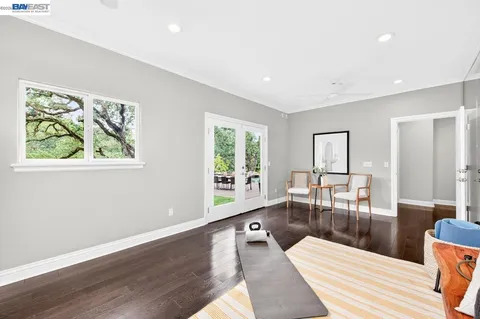 a bedroom with a white bed and a chandelier