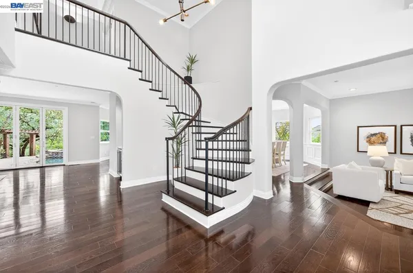 a bedroom with a bed and a wooden floor
