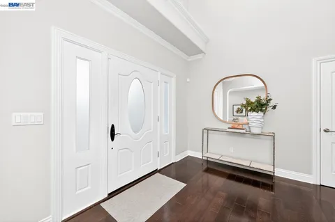 a view of a hallway with entryway wooden floor and front door