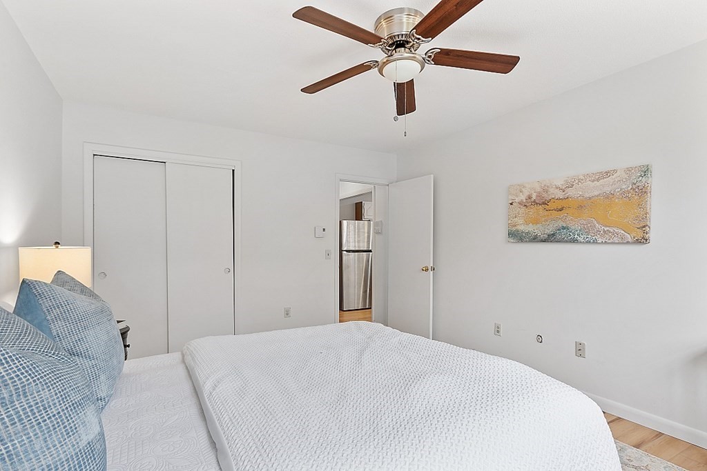 6 Leonard Road, Unit 6 Boxborough, MA 01719 - Photo 13 of 28 a bedroom with a large bed and a chandelier