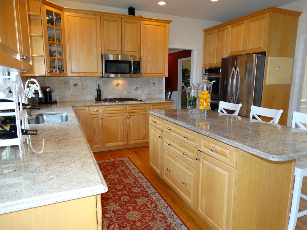 73 Hardwick Road Ashland, MA 01721 - Photo 4 of 30 a kitchen with stainless steel appliances granite countertop a sink refrigerator and microwave