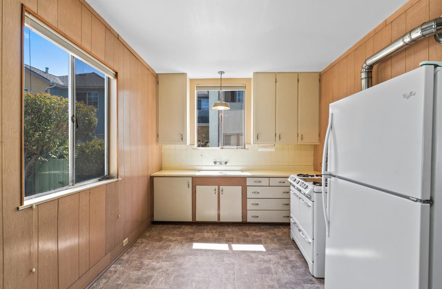 716 Prospect Row San Mateo, CA 94401 - Photo 13 of 39 a kitchen with a refrigerator and a sink