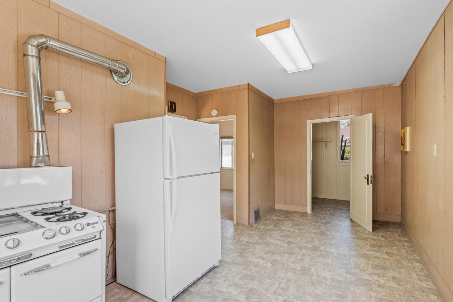 716 Prospect Row San Mateo, CA 94401 - Photo 14 of 39 a white refrigerator freezer and a stove sitting inside of a kitchen