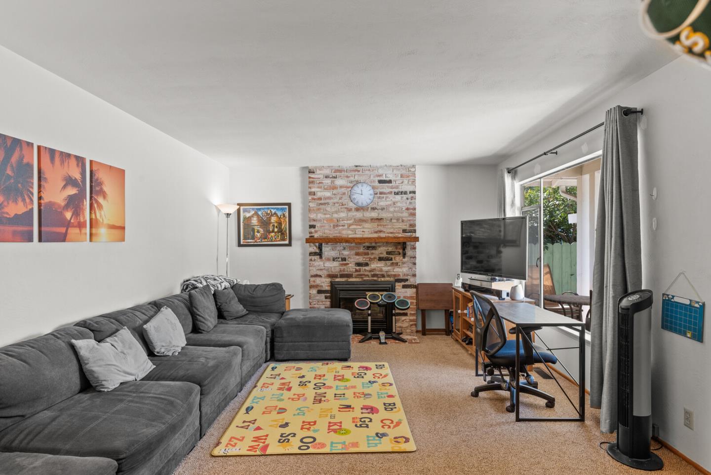 716 Prospect Row San Mateo, CA 94401 - Photo 19 of 39 a living room with furniture flat screen tv and a fireplace