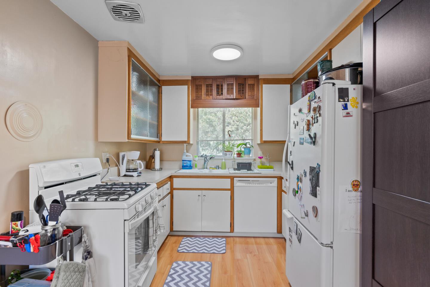 716 Prospect Row San Mateo, CA 94401 - Photo 23 of 39 a kitchen with a sink a refrigerator and a stove