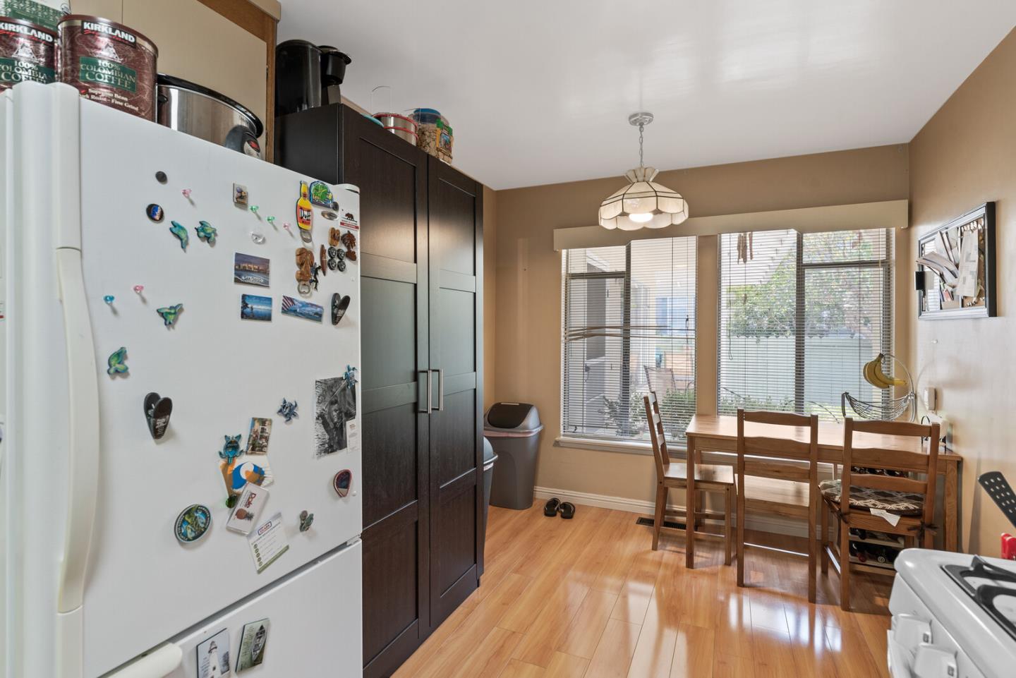 716 Prospect Row San Mateo, CA 94401 - Photo 26 of 39 a dining room with furniture a chandelier and wooden floor