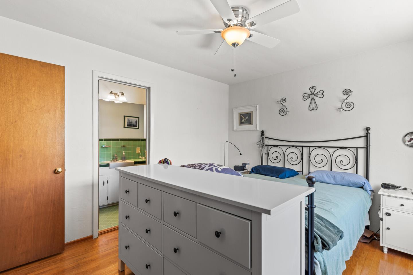 716 Prospect Row San Mateo, CA 94401 - Photo 31 of 39 a view of a room with baby crib and wooden floor