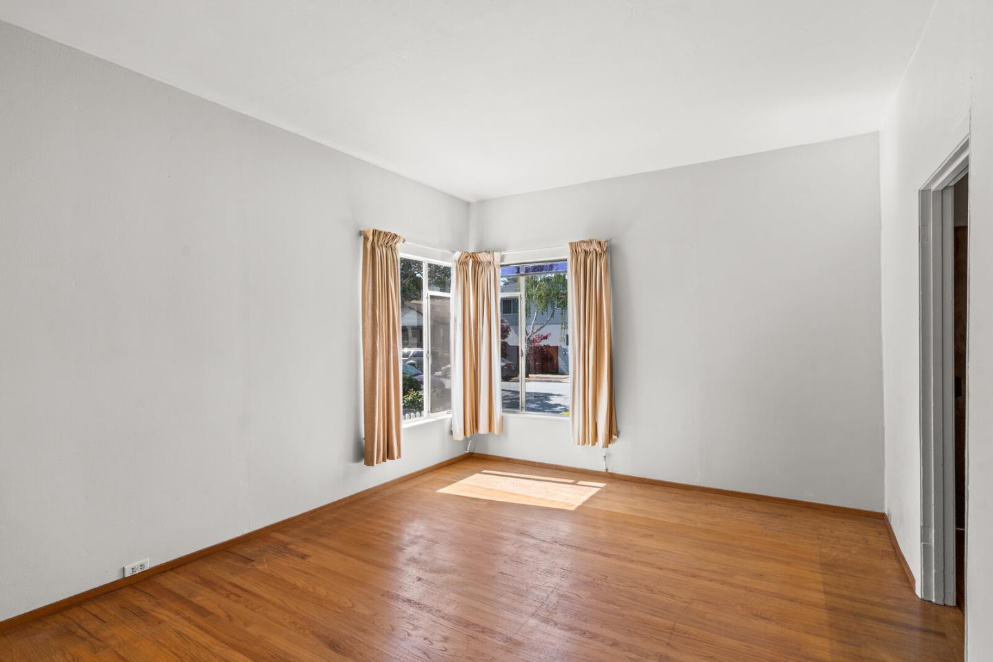 716 Prospect Row San Mateo, CA 94401 - Photo 5 of 39 a view of an empty room with wooden floor and a window