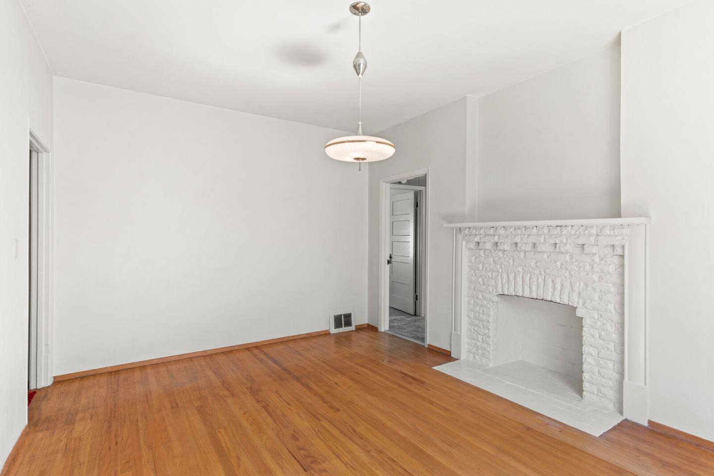 716 Prospect Row San Mateo, CA 94401 - Photo 8 of 39 a view of empty room with wooden floor and fireplace