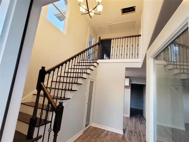 a view of entryway and hall with wooden floor
