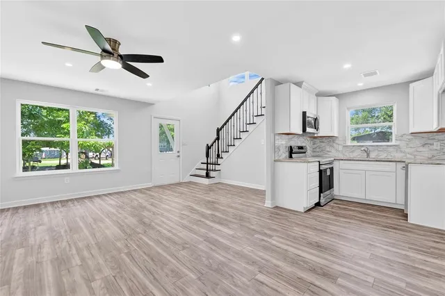 a view of kitchen with sink and wooden floor