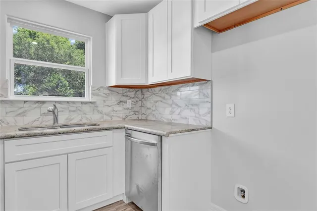a kitchen with a sink and cabinets
