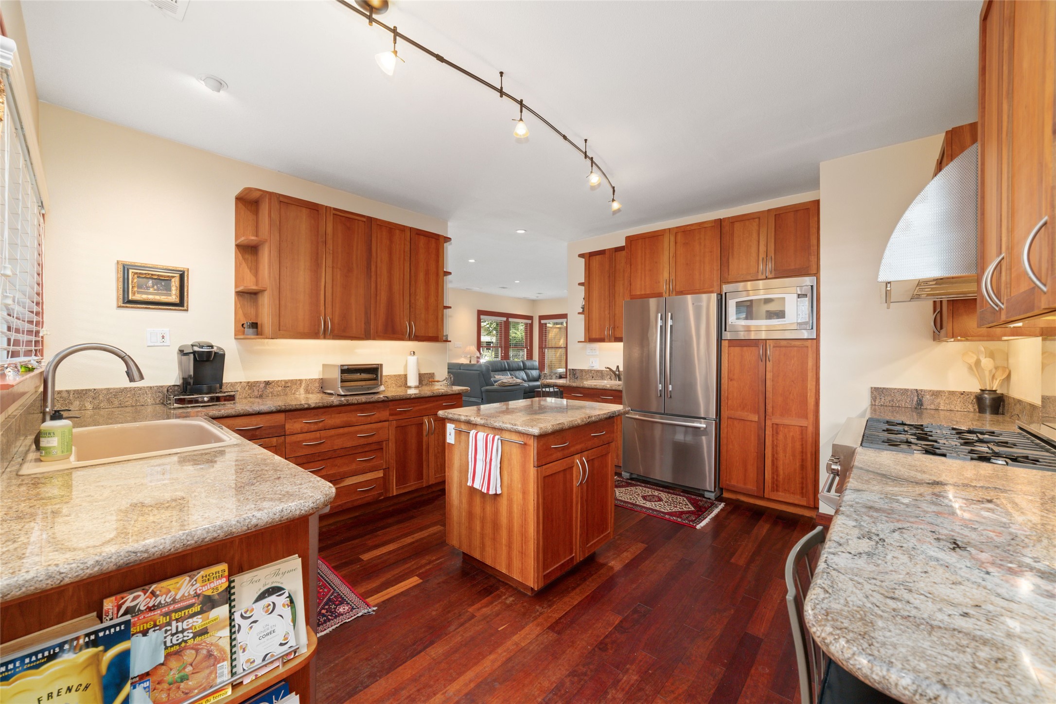 1613 California Street Houston, TX 77006 - Photo 19 of 50 Beautifully designed for both everyday living and effortless entertaining, the kitchen showcases rich Brazilian cherry floors, handcrafted custom cabinetry, premium appliances, and an oversized island at its heart. Thoughtful details and exceptional storage reflect a home that has been lovingly curated over time.