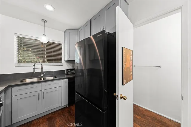 a kitchen with stainless steel appliances granite countertop a refrigerator and a sink