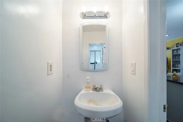a bathroom with a sink and mirror