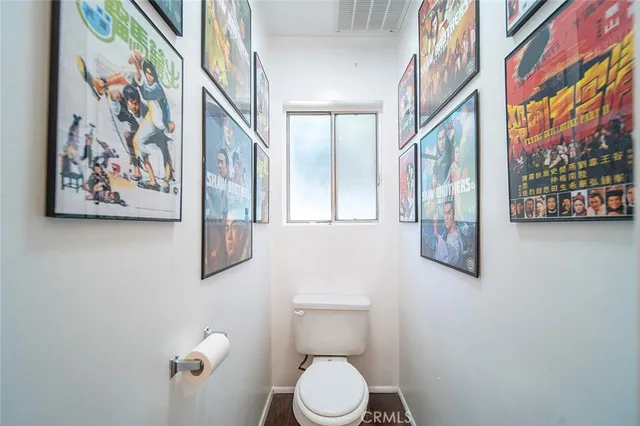 a white toilet sitting next to a small bathroom