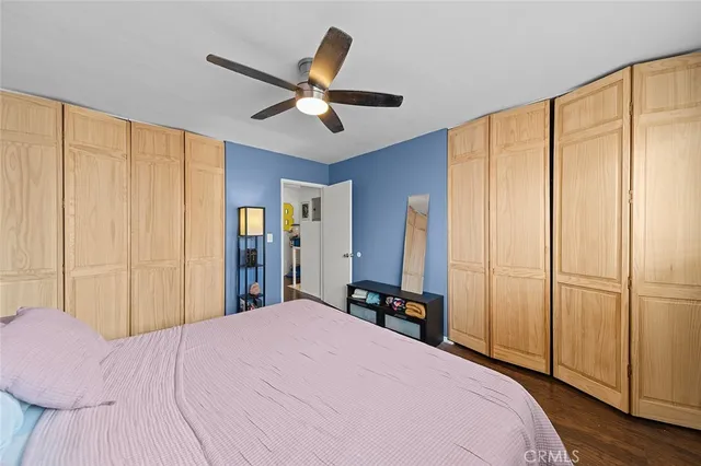 a bed room with a bed and a large mirror