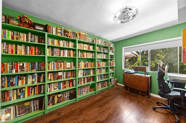 a room with furniture book shelf and wooden floor