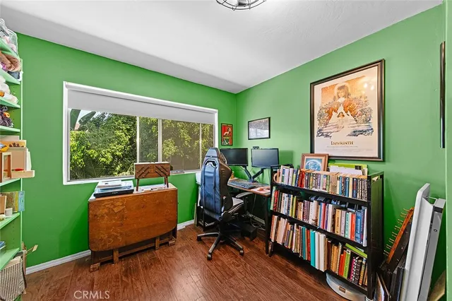 a living room with furniture and a book shelf