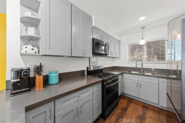 a kitchen with stainless steel appliances granite countertop a sink stove and cabinets