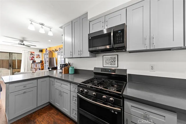 a kitchen with stainless steel appliances a sink dishwasher stove and microwave
