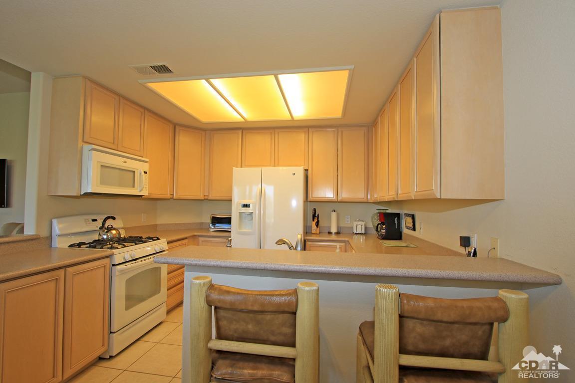 15 Augusta Drive Rancho Mirage, CA 92270 - Photo 11 of 35 a kitchen with a sink cabinets and a window