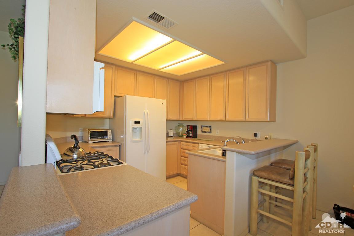 15 Augusta Drive Rancho Mirage, CA 92270 - Photo 12 of 35 a kitchen with a sink stove and refrigerator