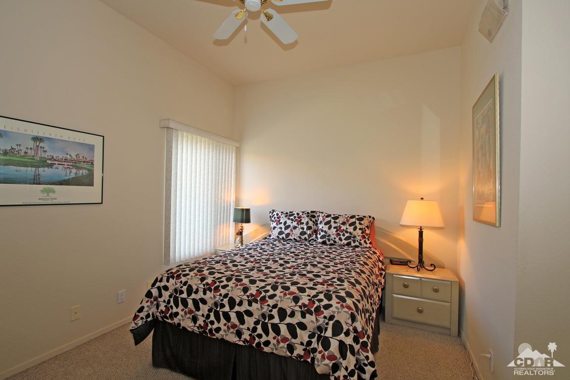 15 Augusta Drive Rancho Mirage, CA 92270 - Photo 20 of 35 a bedroom with a bed and a lamp