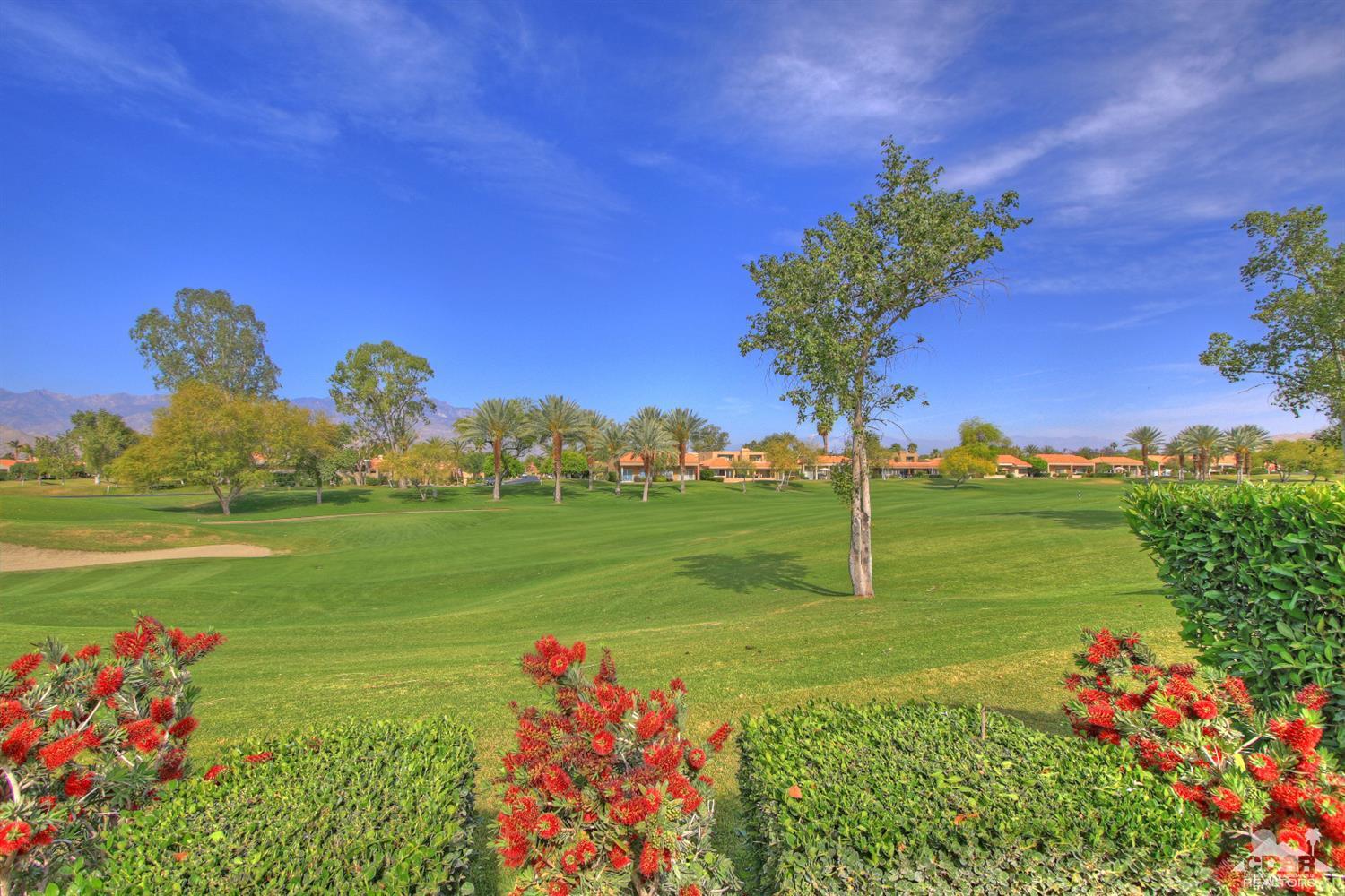 15 Augusta Drive Rancho Mirage, CA 92270 - Photo 2 of 35 a view of a garden with a building in the background