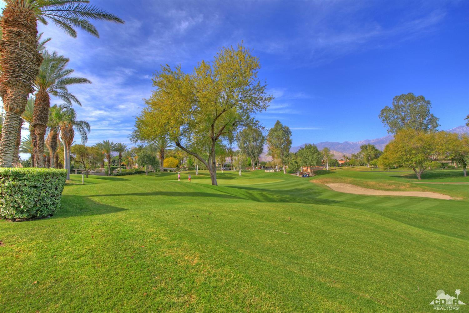15 Augusta Drive Rancho Mirage, CA 92270 - Photo 25 of 35 a view of a golf course with a lake