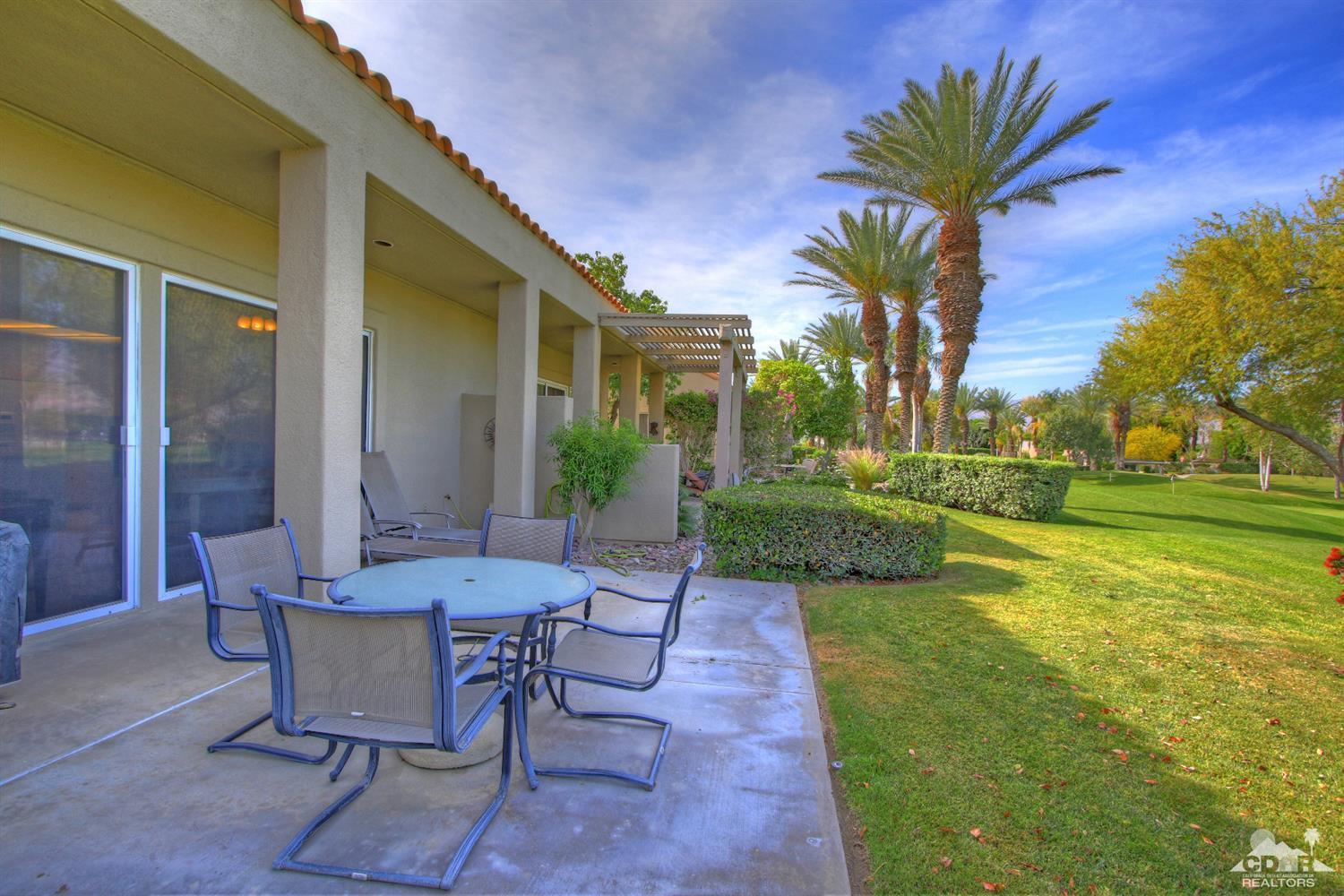 15 Augusta Drive Rancho Mirage, CA 92270 - Photo 28 of 35 a view of a patio with table and chairs and a barbeque with potted plants