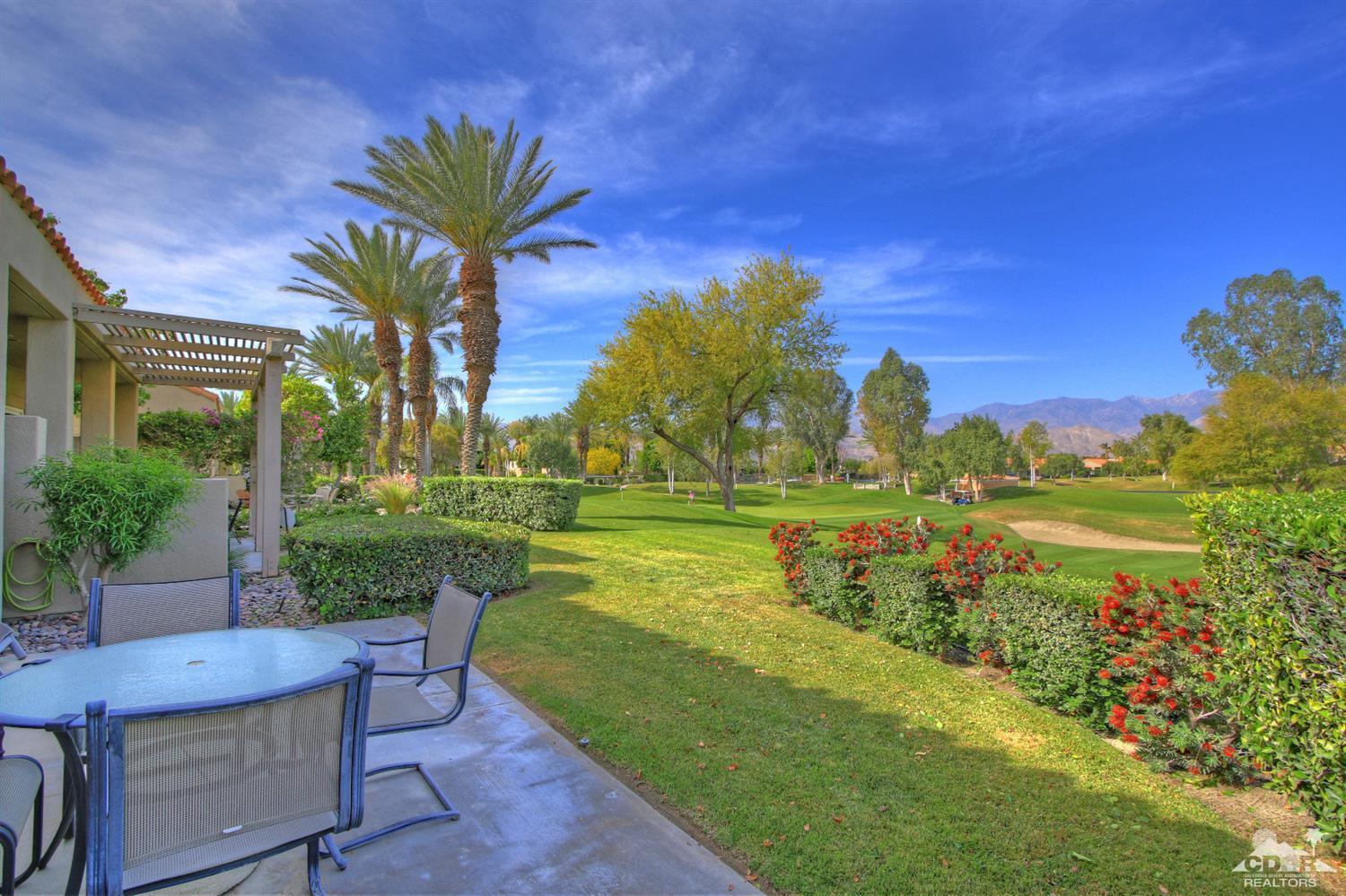 15 Augusta Drive Rancho Mirage, CA 92270 - Photo 4 of 35 a view of a lake with a house in the background