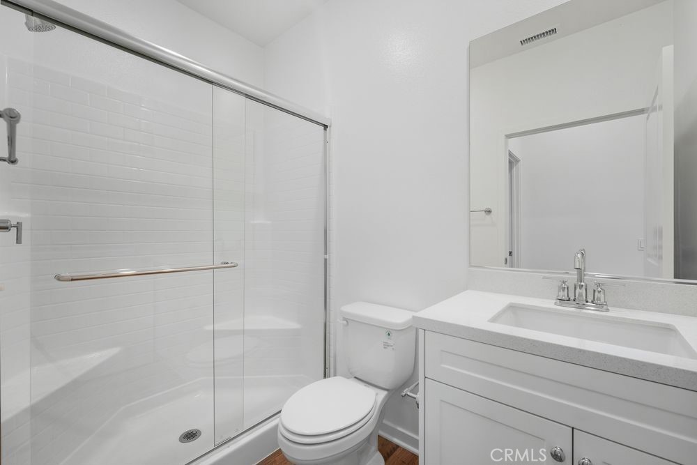 9575 Silverstein Drive Riverside, CA 92508 - Photo 11 of 22 a bathroom with a shower a toilet and sink