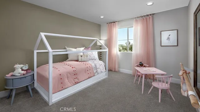 a bedroom with a bed chair and window