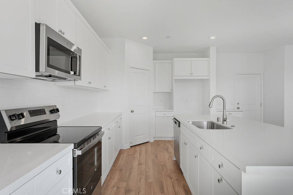 9575 Silverstein Drive Riverside, CA 92508 - Photo 3 of 22 a kitchen with a sink and a stove top oven
